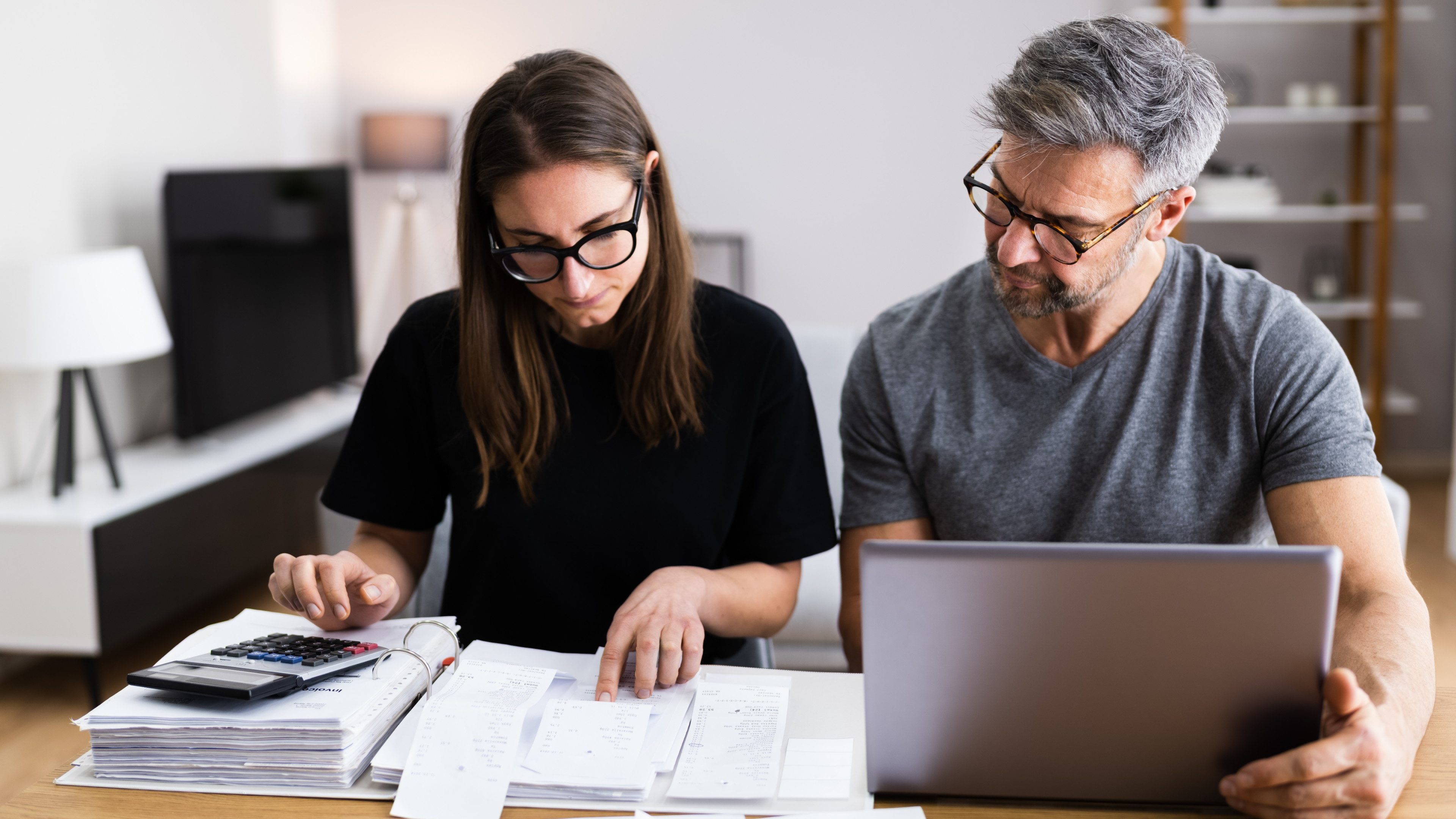 Couple Doing Taxes And Family Budget On Computer