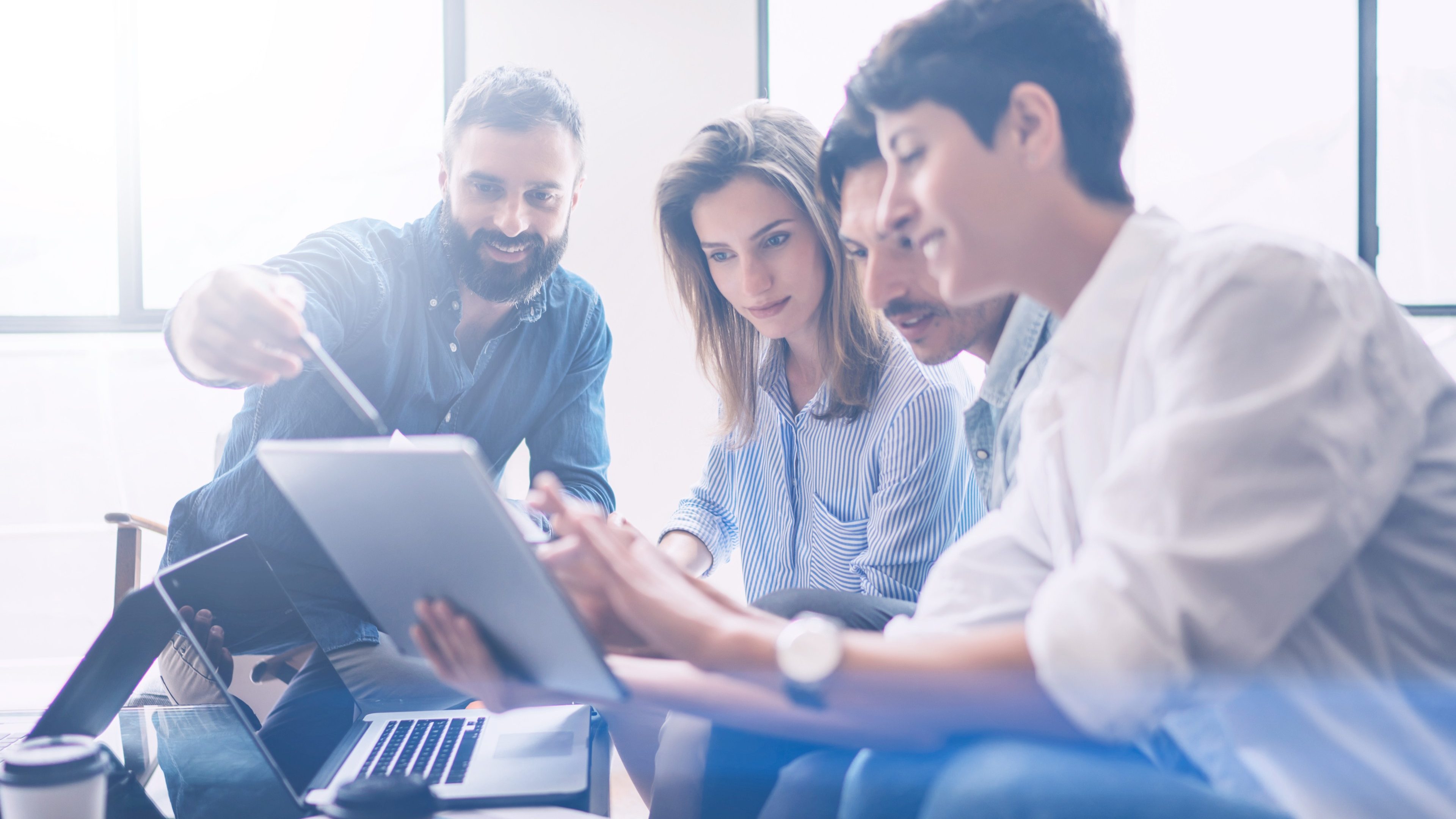 Business meeting concept.Coworkers team working new startup project at modern office.Analyze business documents, using touch tablet.Blurred background.Horizontal.