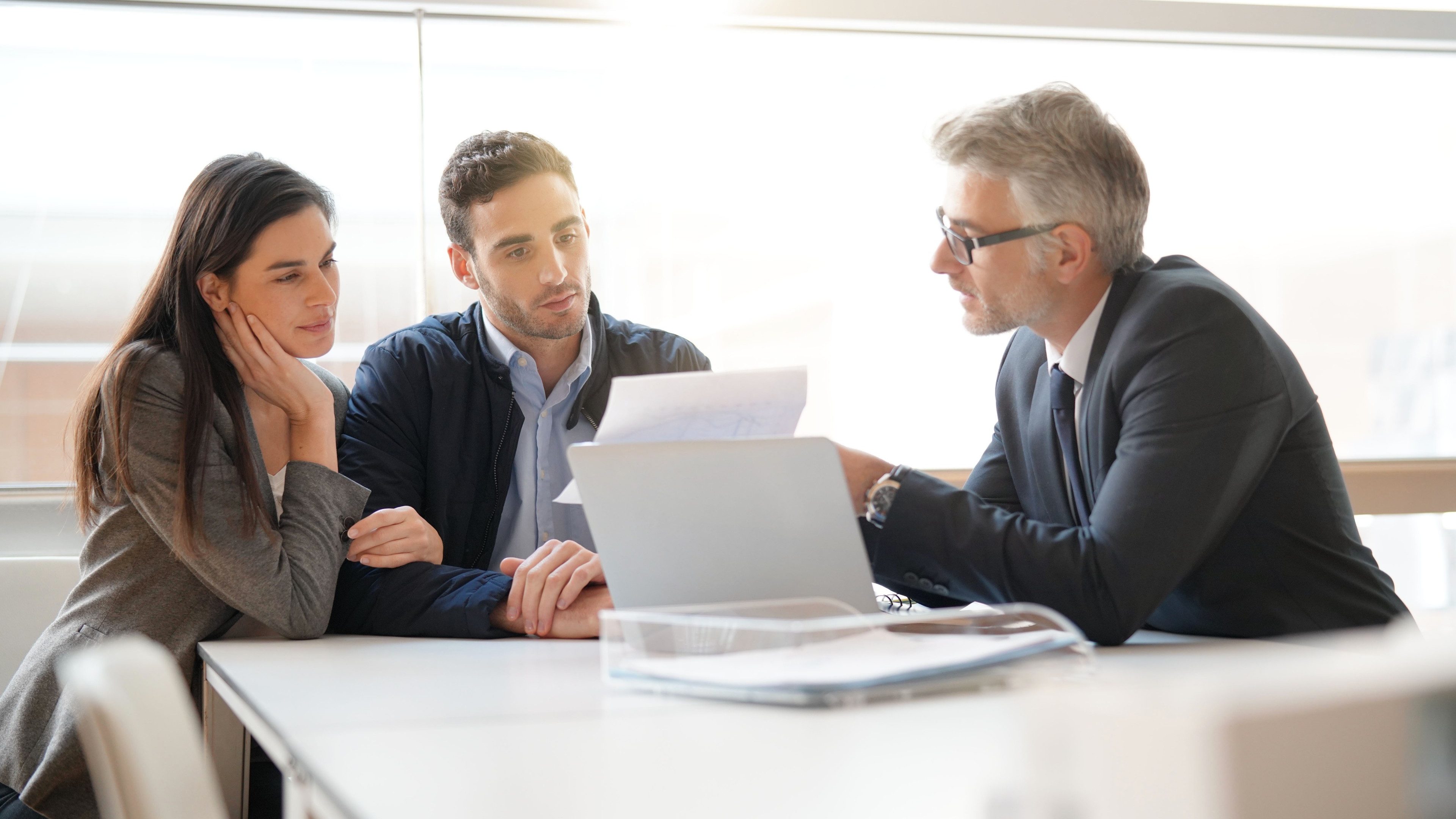 Young couple meeting financial advisor for home investment