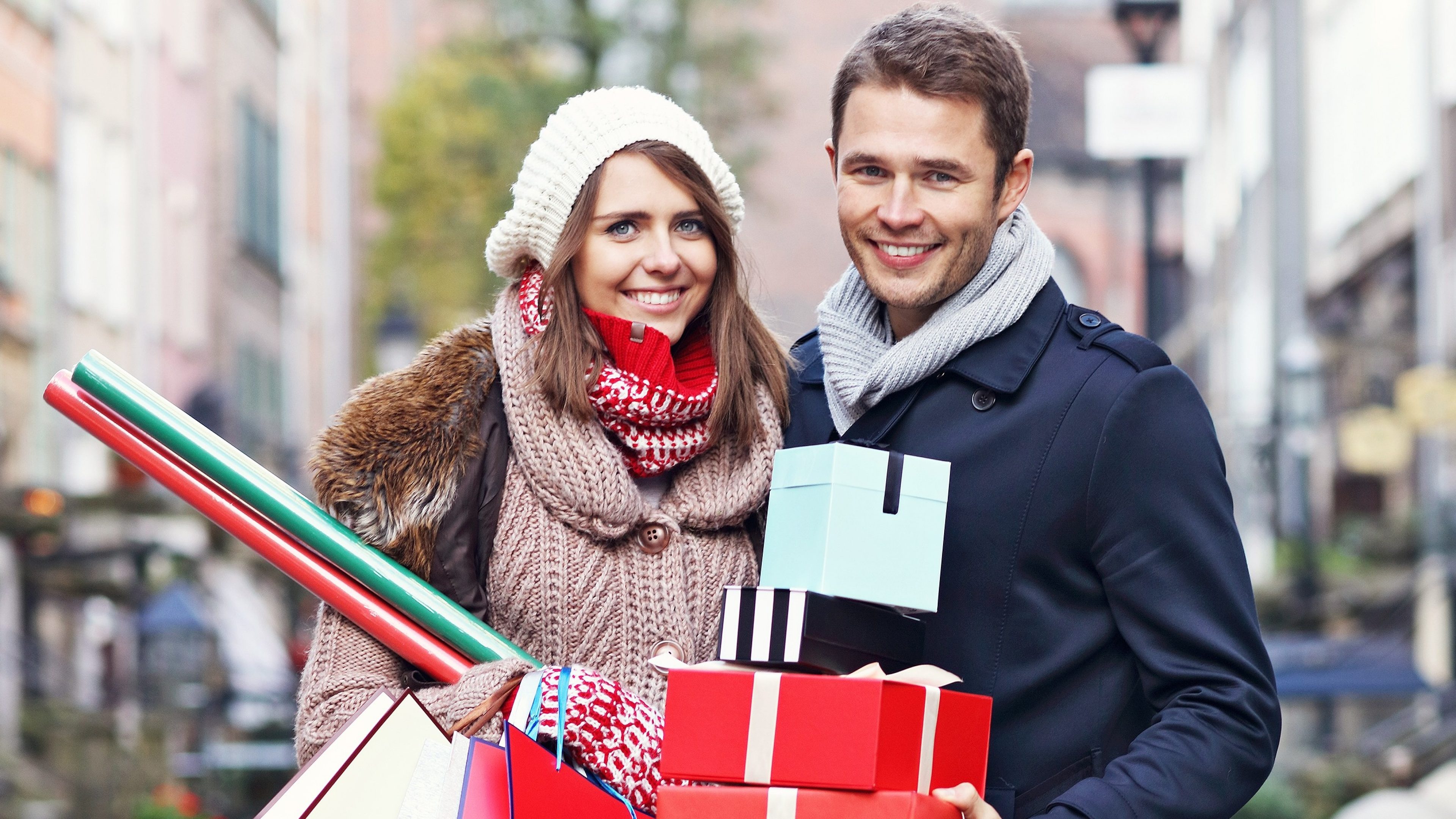 Picture showing young couple doing Christmas shopping in the city