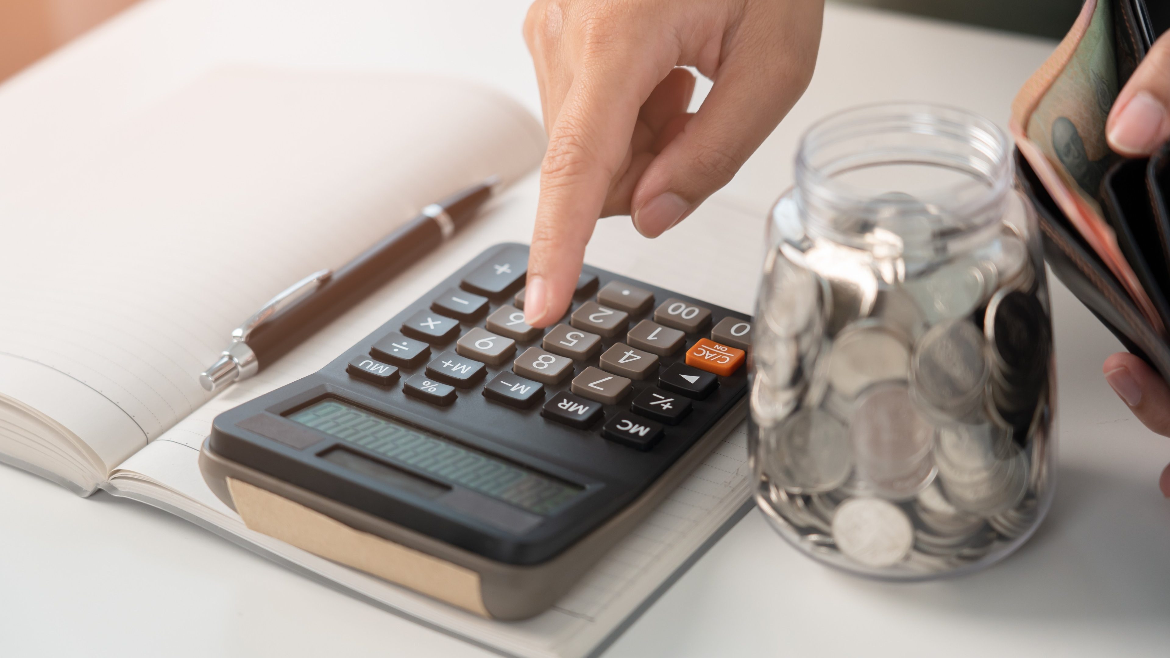 Woman calculating money coin for household saving. Save money in coin jar and do accounting during inflation crisis. Planning budget for home bill payment.